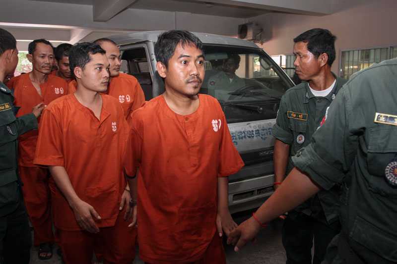 From center to left: Serey Bunlong, Im Phearun and Seng Sok Meng arrive at the Phnom Penh Municipal Court on Tuesday for their trial on charges of supporting US-based dissident Sourn Serey Ratha in a plot to overthrow the government. (Siv Channa/The Cambodia Daily)