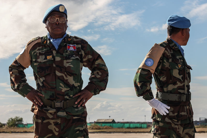 Mam Neang, left, a colonel in the army's Engineering Company 621, stands on the tarmac of the Phnom Penh Military Airbase on Thursday. (Chris Mueller/The Cambodia Daily)