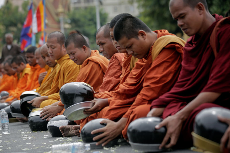 Monks Turn Over Alms Bowls to Protest Jailing of Activists 1 Monks overturn their alms bowls in protest outside the Justice Ministry in Phnom Penh on Thursday. (Siv Channa/The Cambodia Daily)