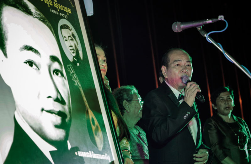 Sisamouth’s Family Awarded Copyright for 73 Songs 1 Sinn Chanchhaya, son of Sinn Sisamouth, sings next to a poster of his father at the Ministry of Commerce in Phnom Penh on Wednesday. (Siv Channa/The Cambodia Daily)