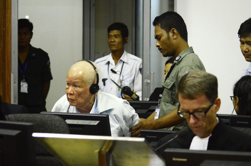 Khieu Samphan is helped into his seat prior to Thursday's hearing in the second phase of Case 002 at the Khmer Rouge tribunal. (ECCC)
