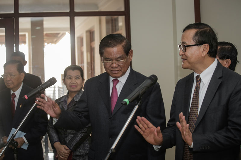 Interior Minister Sar Kheng and opposition leader Sam Rainsy speak to reporters Thursday after meeting for the first time as the leaders of the ruling and opposition party's parliamentary delegations. (Siv Channa/The Cambodia Daily)