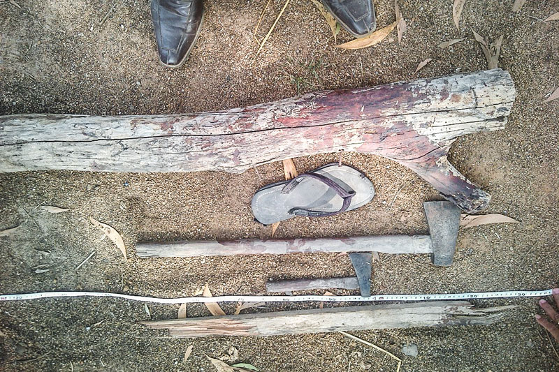Weapons and other pieces of evidence are arranged on the ground following a fight that broke out on the dance floor at a post-harvest festival in Pursat province's Krakor district on Sunday. (Keo Sokunthea)