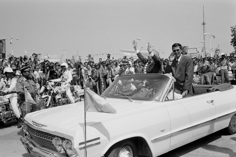 Prime Minister Hun Sen and then-Prince Norodom Sihanouk are paraded through Phnom Penh in November 1991 upon the prince's return from exile after the signing of the Paris Peace Agreement. (John Vink)