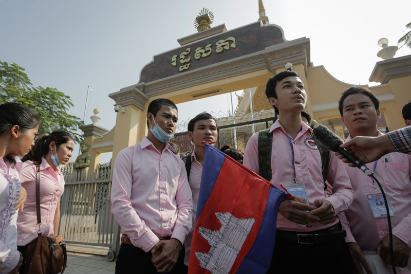 Nursing students from the International Science Institute in Phnom Penh stand outside the National Assembly, where they submitted a petition Wednesday calling on lawmakers to spur the government into taking action against their unlicensed school. (Siv Channa/The Cambodia Daily )