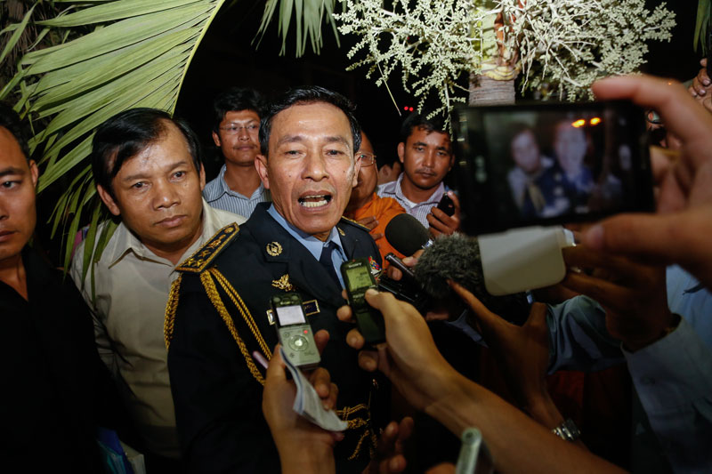Nov Leakhena, deputy director of the immigration department, speaks with reporters outside the department's headquarters last night. (Siv Channa/The Cambodia Daily)