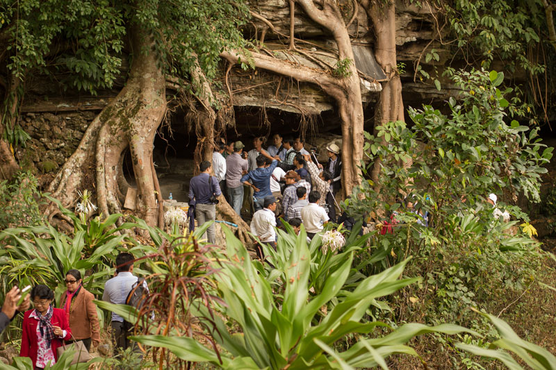 Journalists gather around CNRP spokesman Yem Ponhearith on Thursday at a cave on Bokor Mountain in Kampot province where Vietnamese tourists are said to hold prayer ceremonies. (Alex Willemyns/The Cambodia Daily)