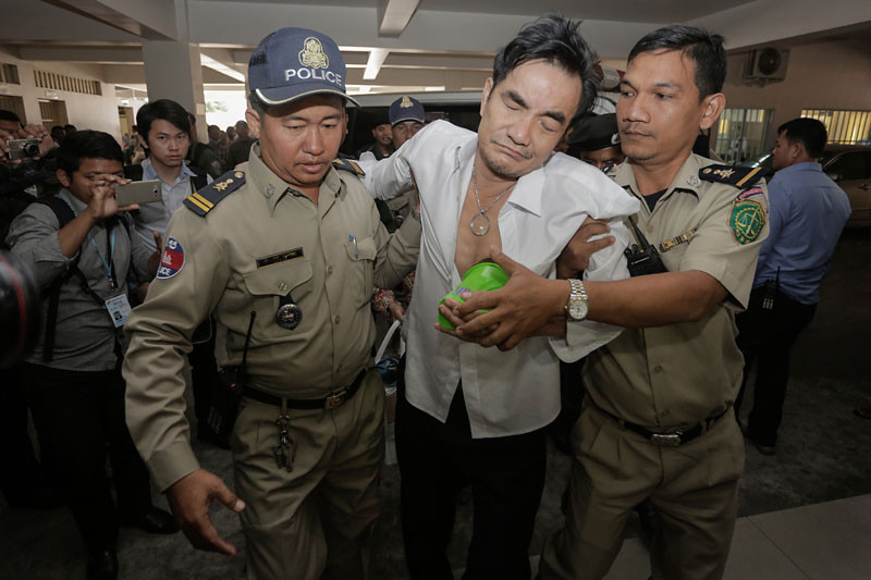 Thong Chamroeun enters the Phnom Penh Municipal Court yesterday after he and his wife were arrested while heading toward the Vietnamese border in an ambulance on Sunday night. (Siv Channa/The Cambodia Daily)