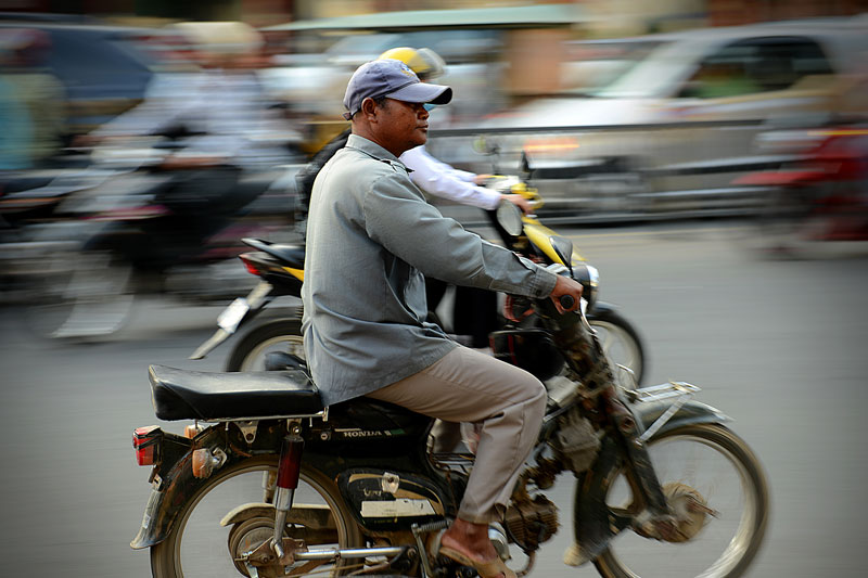 A man drives a motorbike without a helmet on a busy street in Phnom Penh on Tuesday. (Matt Walker)