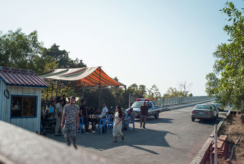 Two tourists are sent back after attempting to cross the bridge to Sihanoukville's Koh Puos island on Wednesday. (Joe Hofmann)