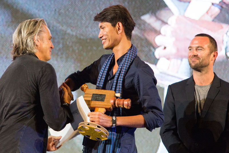 Polen Ly, center, shakes hands with Mike Ellis, president of the Motion Picture Association for the Asia-Pacific region, after winning the Tropfest South East Asia short-film festival in Malaysia on Sunday. (Tropfest)