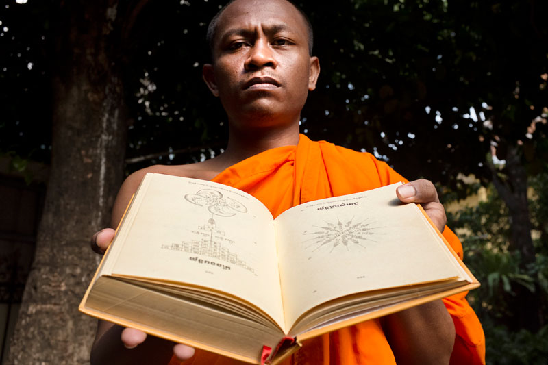 Monk Chy Samoeun holds his book of holy tattoo designs at Phnom Penh’s Wat Ounalom in August. (Rick Valenzuela)