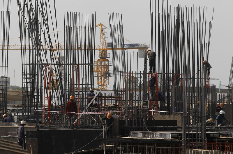 Laborers work at a construction site in Phnom Penh on Tuesday. (Pring Samrang/Reuters)