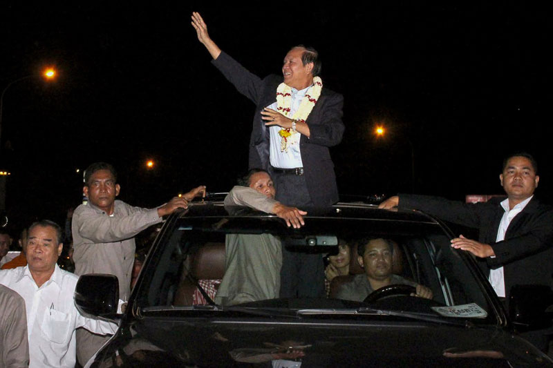 CNRP Vice President Kem Sokha waves to supporters outside Phnom Penh International Airport upon returning to Cambodia Wednesday night, in a photograph posted to his Facebook page.