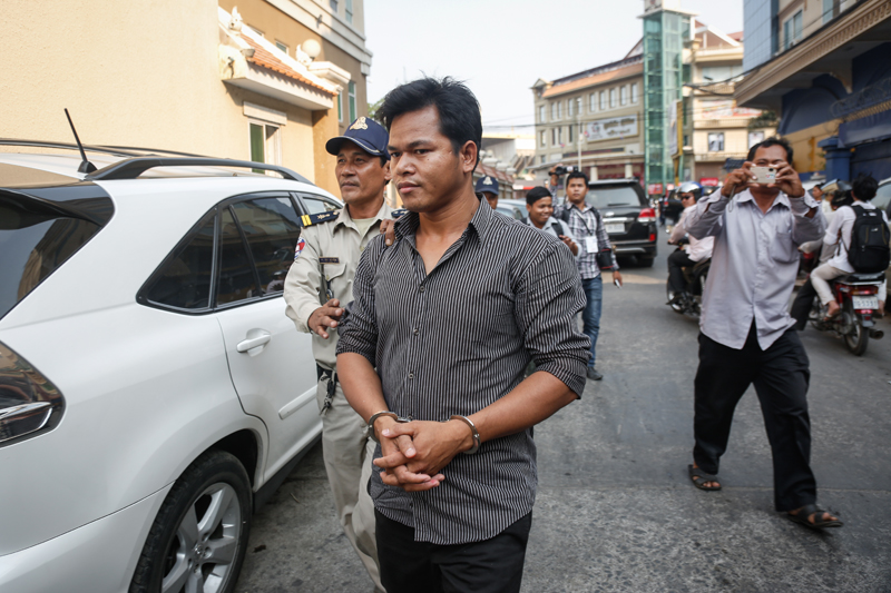 Run Chanthoeun is escorted from the municipal court Thursday. (Siv Channa/The Cambodia Daily)