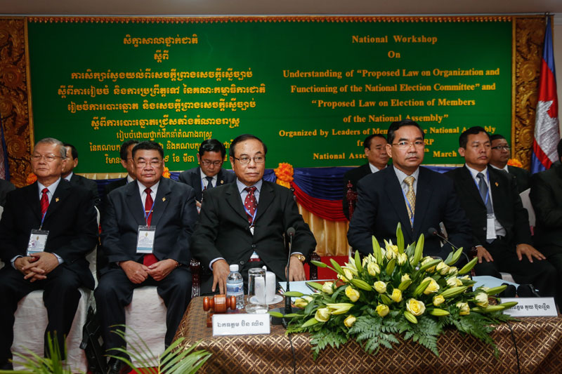 Deputy Prime Minister Bin Chhin, front left, and CNRP official Kuoy Bunroeun, center right, preside over a workshop Monday to promote the new election laws they spent the last seven months drafting. (Siv Channa/The Cambodia Daily)
