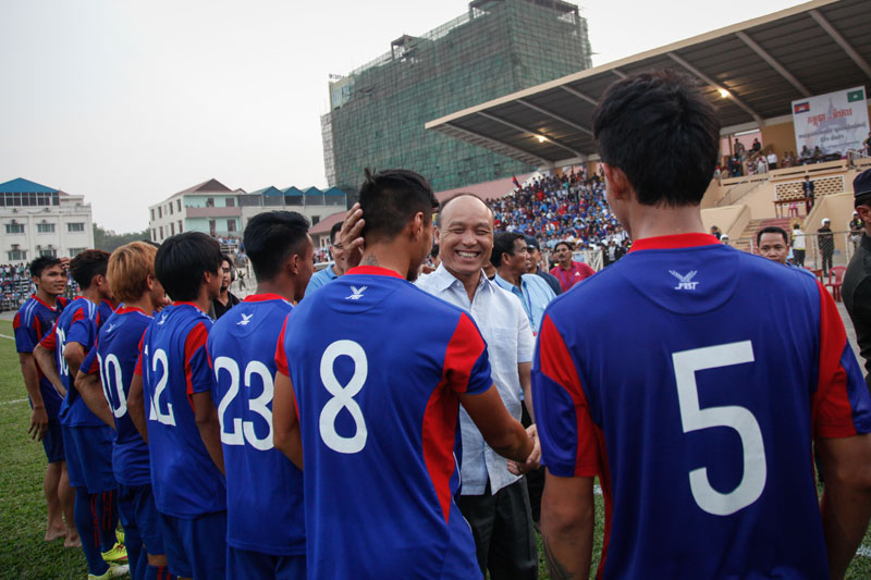 General Sao Sokha, commander of the military police and president of the Football Federation of Cambodia, congratulates national team players after they beat Macau 3-0 in their first World Cup qualifier at Phnom Penh's Old Stadium on Thursday. (Siv Channa/The Cambodia Daily)