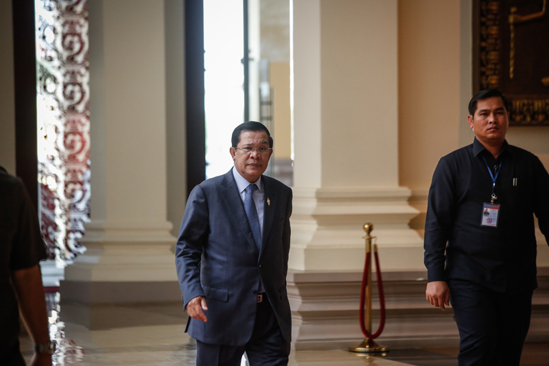 Prime Minister Hun Sen arrives at the National Assembly in Phnom Penh on Thursday morning ahead of a special session to pass two new election laws. (Siv Channa/The Cambodia Daily)