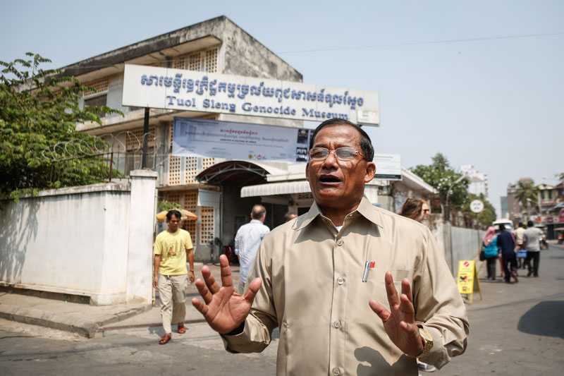 Nhem En, a former photographer at Phnom Penh's S-21 prison, speaks Thursday outside the compound, which has since become a museum. (Siv Channa/The Cambodia Daily)