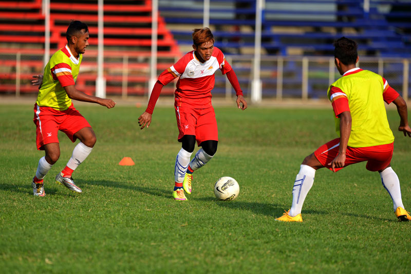 Chan Vathanaka dribbles the ball during a national team practice at Phnom Penh's Old Stadium on Sunday. (Matt Walker)