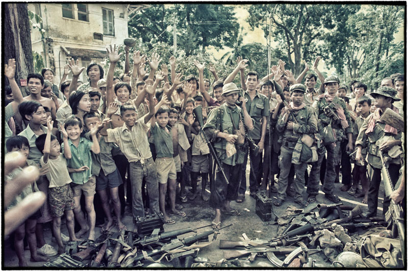 Children and teenagers welcome the Khmer Rouge soldiers on April 17, 1975. (Roland Neveu)