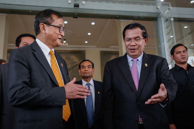 Opposition leader Sam Rainsy, left, and Prime Minister Hun Sen speak to reporters at a joint press conference after the National Assembly approved the composition of the new National Election Committee on Thursday. (Siv Channa/The Cambodia Daily)