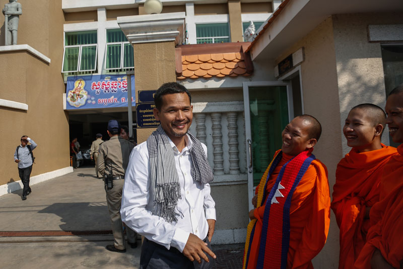 CNRP official Meach Sovannara, one of 11 opposition activists who had their trial delayed Monday, stands outside the municipal court. (Siv Channa/The Cambodia Daily)