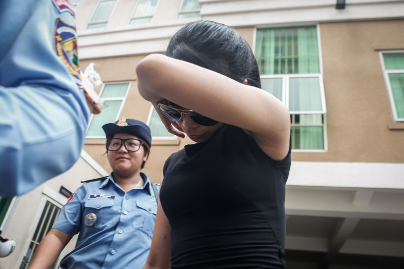 Ung Kolzanich is escorted from the Phnom Penh Municipal Court after questioning Thursday. (Siv Channa/The Cambodia Daily)