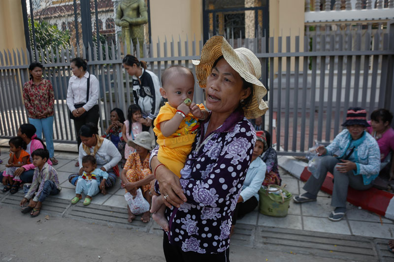 Representatives of families in a land dispute with the Defense Ministry gather outside the National Assembly in Phnom Penh on Thursday. (Siv Channa/The Cambodia Daily)