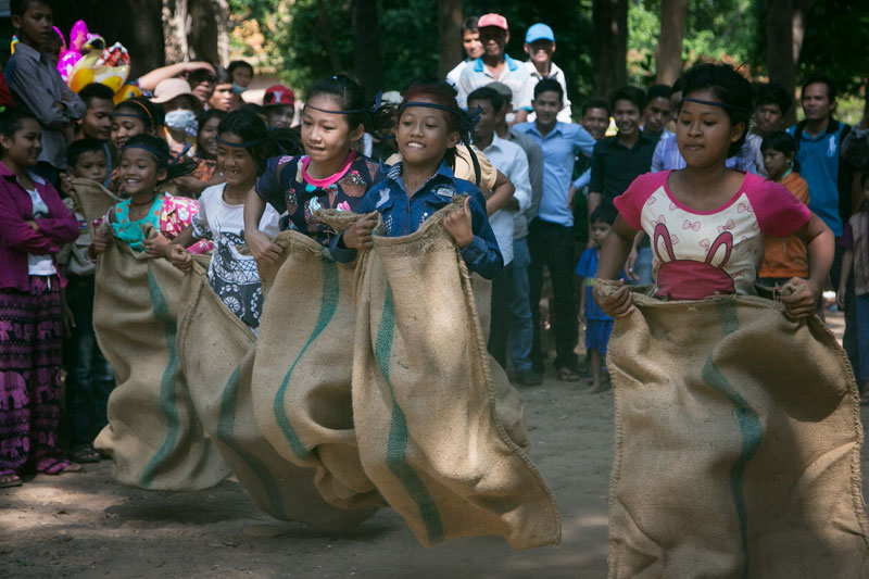 Girls compete in a sack race at Phnom Penh's Wat Phnom on Tuesday afternoon. (Ottavia Fabbri/The Cambodia Daily)
