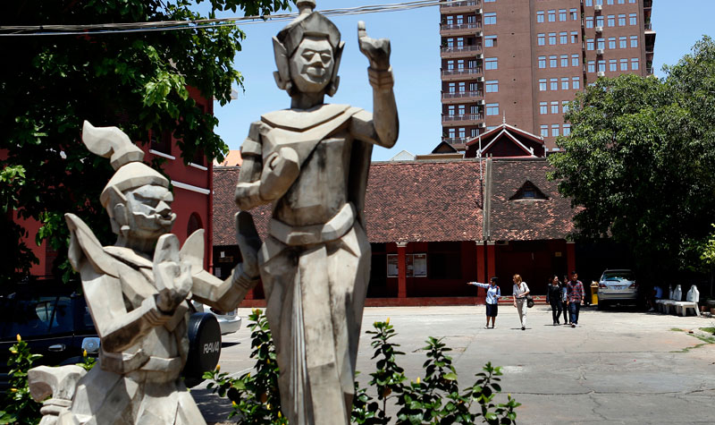 People walk around the grounds of the Royal University of Fine Arts on Thursday. (Siv Channa/The Cambodia Daily)