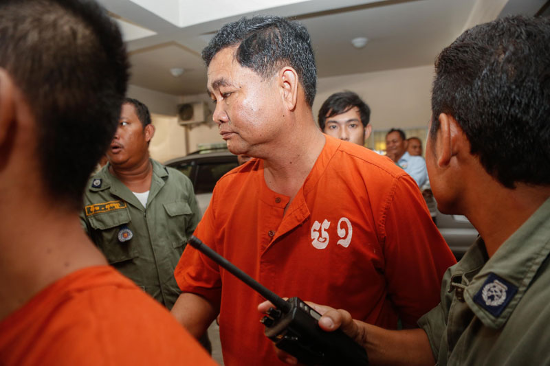 Phy Nop is escorted from the Phnom Penh Municipal Court on Tuesday. (Siv Channa/The Cambodia Daily)