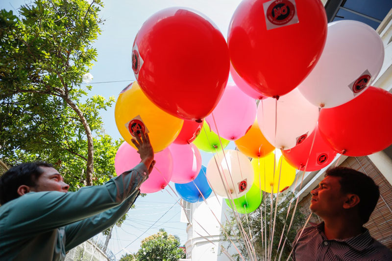 NGO workers release balloons outside the Phnom Penh office of rights group Adhoc on Monday as part of a campaign urging lawmakers not to approve a draft law regulating nongovernmental groups. (Siv Channa/The Cambodia Daily)
