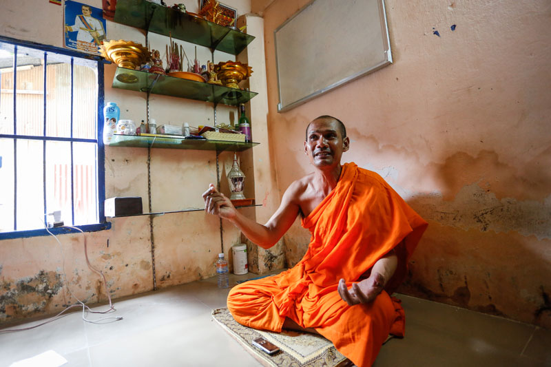 Sot Chaya details his military background in his room in Wat Samakki Raingsey in Phnom Penh earlier this week. (Siv Channa/The Cambodia Daily)