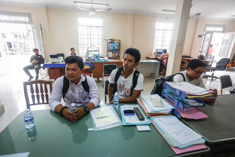  From left: Chek Nitra, Sorn Chandara and Doem Kundy sit inside the Chamkar Mon district office in Phnom Penh on Thursday after being detained over what City Hall deemed an illegal demonstration. (Siv Channa/The Cambodia Daily)
