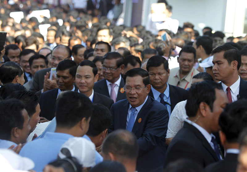 Prime Minister Hun Sen greets supporters at the CPP's Phnom Penh headquarters Sunday. (Pring Samrang/Reuters)