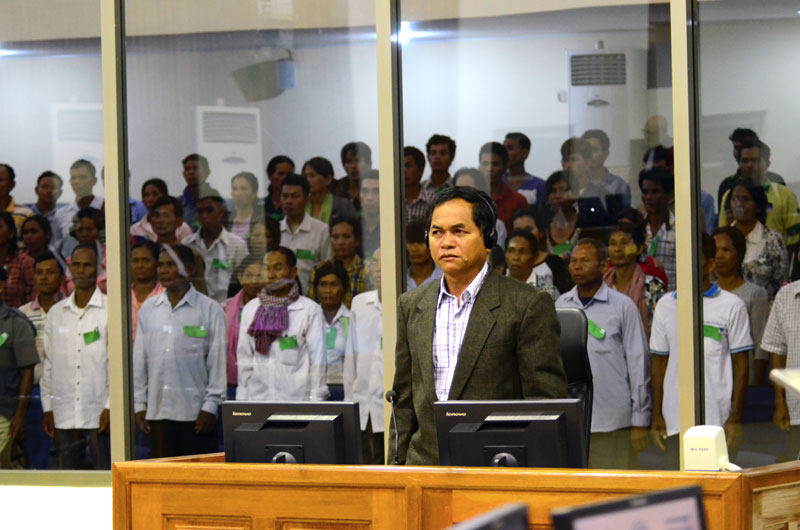 Witness Keo Kin rises as the judges enter the courtroom at the Khmer Rouge tribunal on Thursday. (ECCC)