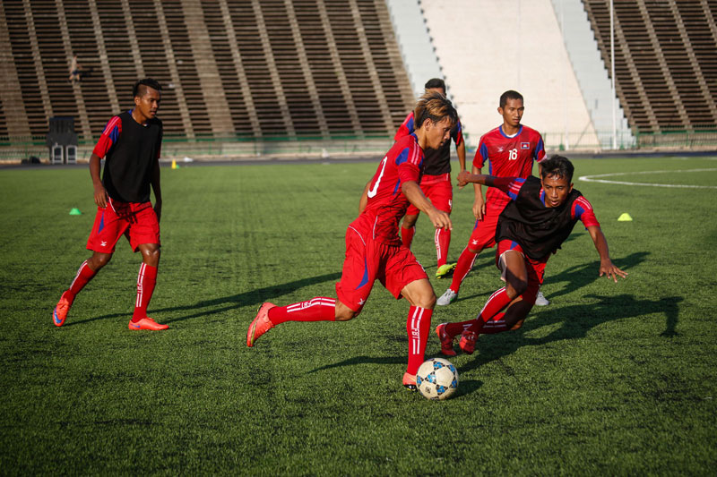 Players on the Cambodian national football team train at Phnom Penh's Olympic Stadium on Wednesday ahead of Thursday's World Cup qualifier against Singapore. (Siv Channa/The Cambodia Daily)