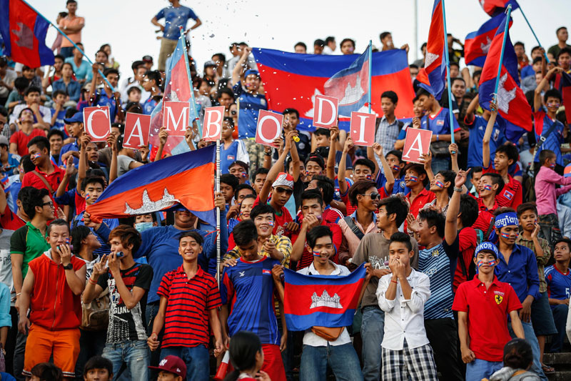 Cambodian football fans cheer before Thursday's World Cup qualifier against Singapore at Olympic Stadium in Phnom Penh. More than 40,000 fans watched the national side lose 4-0 in their opening game of the second round. (Siv Channa/The Cambodia Daily)