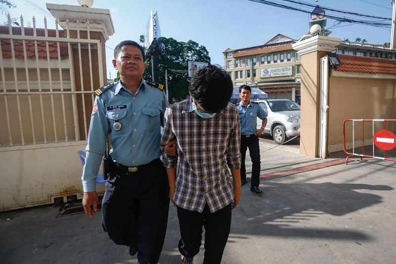 Tann Sovannara is escorted into the Phnom Penh Municipal Court on Thursday to be questioned over a series of hit and runs on Tuesday. (Siv Channa/The Cambodia Daily)