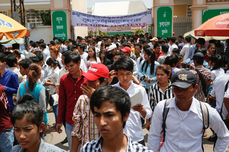 Prospective migrant workers leave Chaktomuk Junior High School in Phnom Penh on Sunday after taking a Korean-language test. (Siv Channa/The Cambodia Daily)