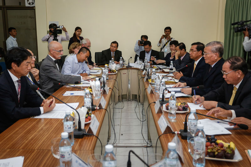 Members of the National Election Committee (NEC), at right, meet with delegates from the European Union and Japan at the NEC's offices inside the Interior Ministry in Phnom Penh on Monday. (Siv Channa/The Cambodia Daily)