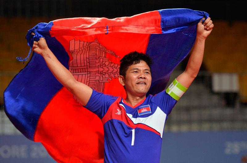 Competitor Ung Narith celebrates on Saturday after Cambodia won a gold medal in the sepak takraw chinlone linking event at the 28th Southeast Asia Games in Singapore. (Singapore SEA Games Organizing Committee)