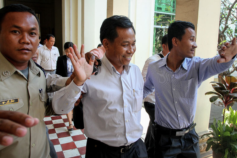 Former Bavet City governor Chhouk Bundith, center, leaves the Appeal Court in Phnom Penh in February 2013. (Siv Channa/The Cambodia Daily)