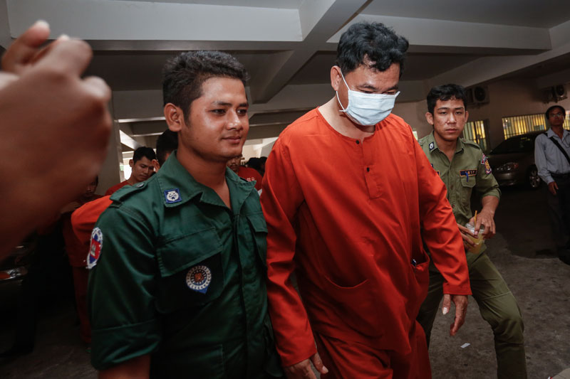 Former Kouk Roka commune chief Phy Nop leaves the Phnom Penh Municipal Court on Thursday after being sentenced to life in prison. (Siv Channa/The Cambodia Daily)