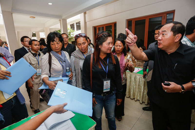 Interior Ministry bodyguard unit chief Touch Naruth, right, talks to a group of women hoping to speak at a workshop on the draft NGO law at the National Assembly in Phnom Penh on Wednesday. (Siv Channa/The Cambodia Daily)
