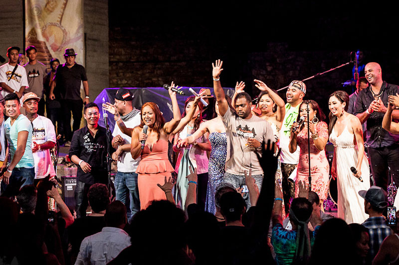 Cambodian Music Festival founder Seak Smith, center left, waves to the crowd during the finale of last year’s show alongside co-founder and husband Brian Smith at the Ford Theatre in Hollywood, California. (Cambodian Music Festival)