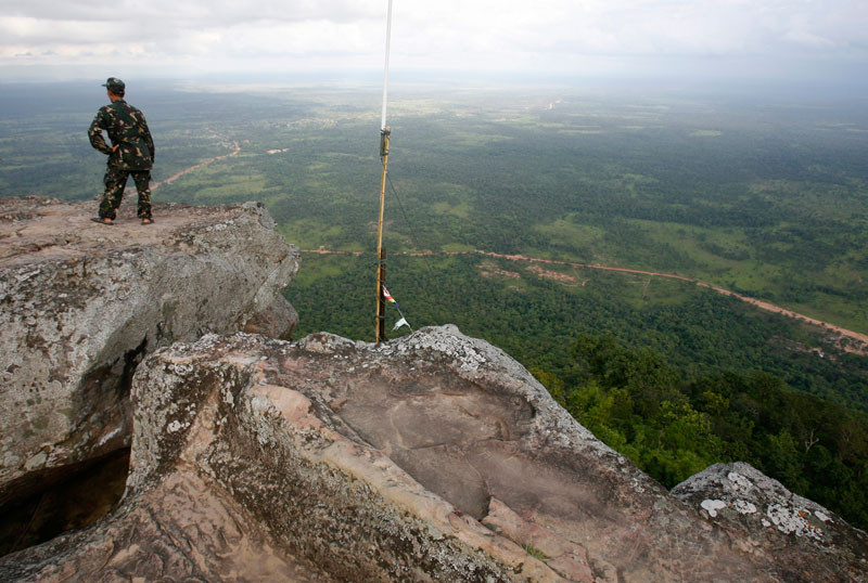 A Cambodian soldier looks out from a cliff in the Dangrek mountains at the Preah Vihear temple compound in 2009. (Reuters)