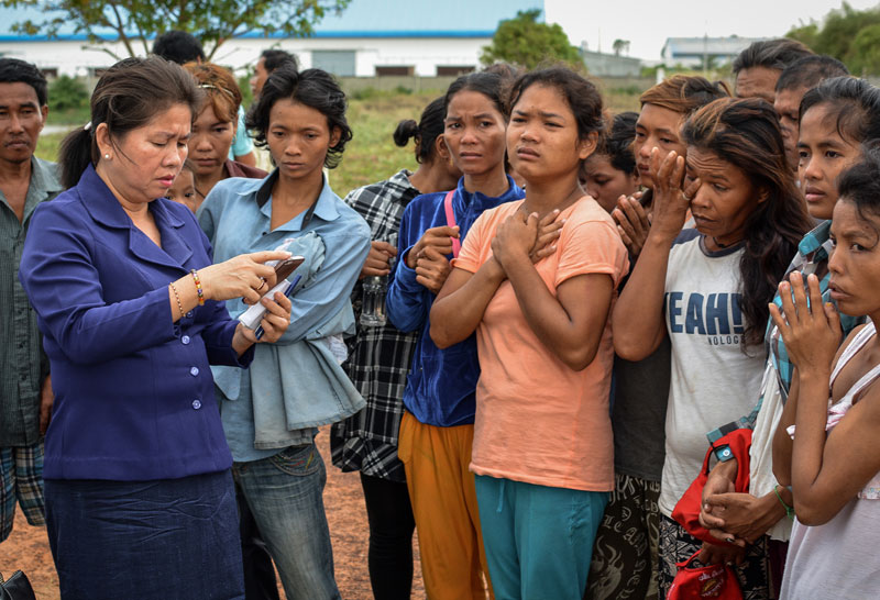 Opposition lawmaker Ke Sovannaroth, left, speaks with detainees at the Pur Senchey Vocational Training Center in Phnom Penh on Tuesday. (Alex Consiglio/The Cambodia Daily)