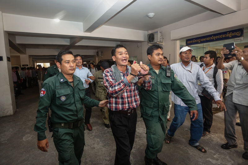 Opposition activist Ouk Pich Samnang leaves the Phnom Penh Municipal Court on Tuesday after being sentenced to seven years in prison for joining an insurrection. (Siv Channa/The Cambodia Daily)